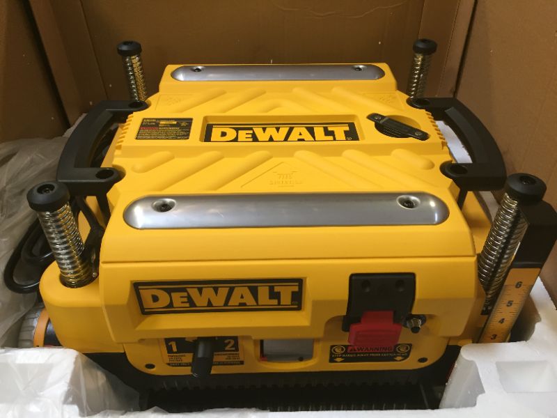 Photo 2 of **parts only** DEWALT 13-Inch Thickness Planer, Three Knife, Two-speed with Protective Safety Glasses (DW735X & DPG55-1C) w/Safety Glasses (has a damaged bed, leaves a huge gouge from the blades when planning right down the center.)