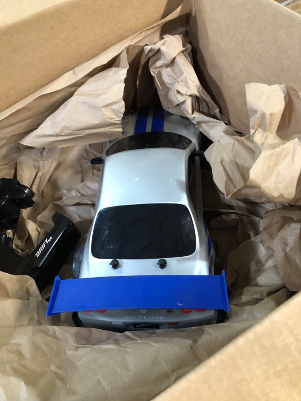 Photo 4 of  * USED * 
Jada Toys Fast & Furious Brian's Nissan Skyline GT-R (BN34) Drift Power Slide RC Radio Remote Control Toy Race Car with Extra Tires, 1:10 Scale, Silver/Blue (99701)