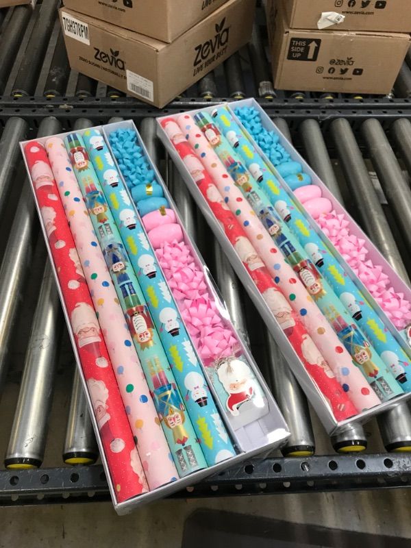Photo 2 of 2----Wrapping Paper, Christmas Wrapping Paper for Kids Boys, Girls, baby. 4 Cute Designs Including Santa, Christmas Lights, Snowman, Nutcracker. Includes Decorative Flowers, Ribbons, Labels. Each Roll of Gift Wrap Paper Measures 27.5 In X 13 ft