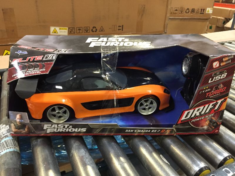 Photo 2 of Jada Toys Fast & Furious Han’s Mazda RX-7 Drift RC Car, 1: 10 Scale 2.4Ghz Remote Control Orange & Black, Ready to Run, USB Charging (Standard) (99700)