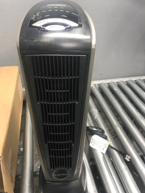 Photo 1 of *** POWERS ON *** Lasko Oscillating Ceramic Tower Space Heater for Home with Adjustable Thermostat, Timer and Remote Control, 22.5 Inches, Grey/Black, 1500W, 751320