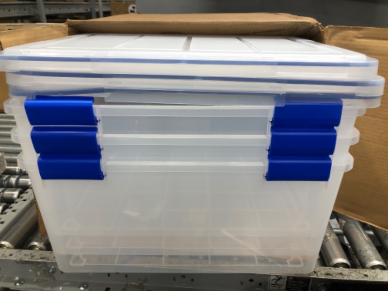 Photo 2 of *Minor Damage to One Lid-See Last Photo* IRIS USA 60 Quart WEATHERPRO Plastic Storage Box with Durable Lid and Seal and Secure Latching Buckles, Clear With Blue Buckles, Weathertight, 3 Pack 60 Quart - 3 Pack