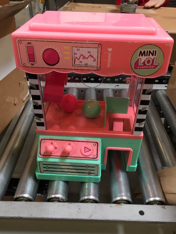 Photo 2 of L.O.L. Surprise! Minis Claw Machine Playset with 5 Surprises with Lights & Exclusive LOL Mini Family, Holiday Toy Great Gift for Kids Girls Boys Ages 4 5 6+ Years Old & Collectors