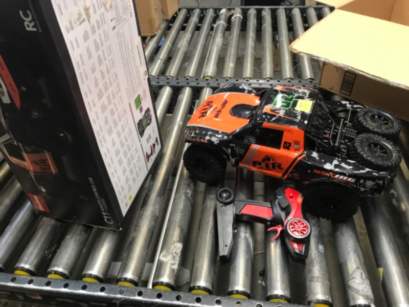 Photo 2 of Bwine Amphibious Remote Control Car, 1:10 Big Size Waterproof RC Cars for Boys Girls, 4WD Off Road Monster Truck for Kids & Adults, 2 Batteries for 40 Min Play, Water Beach Pool Toys
 USED  HAS DEAD BATTERIES AND HAS A SLIGHT TURN TO THE RIGHT SIDE WHEN G