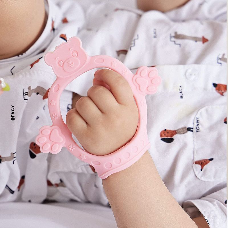 Photo 1 of Adjustable Baby Wrist Teethers for Babies Never Drop Silicone Baby Teething Toys for 0 6 12 Months Infants Toddlers Baby Chew Toys for Sucking Needs (Bear-Pink)