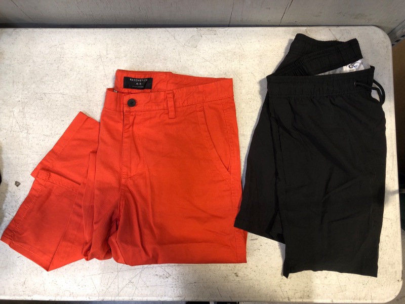 Photo 1 of 2-PIECE MENS CLOTHING BUNDLE: 1 BLACK SHORT US 34; 1 ORANGE PANT 34