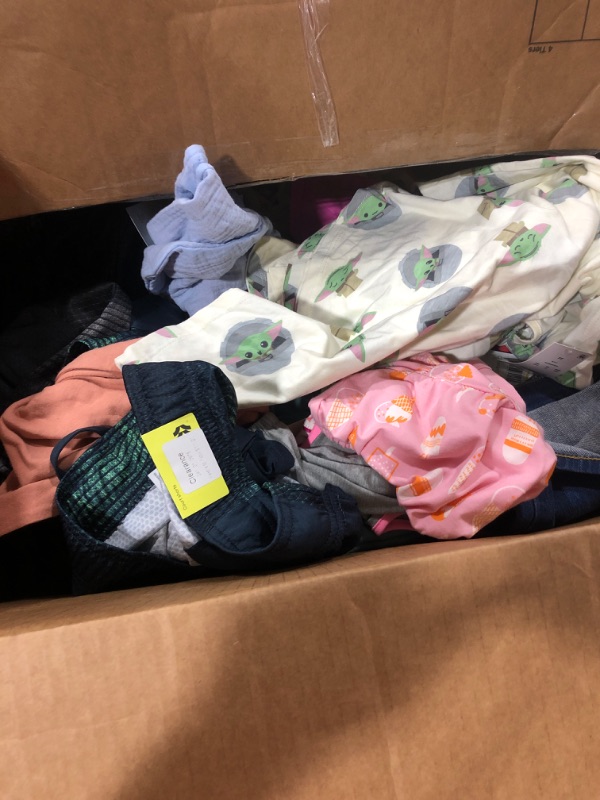 Photo 1 of BOX OF MISC CLOTHING OF VARIOUS SIZES STYLES AND COLORS SOLD AS IS