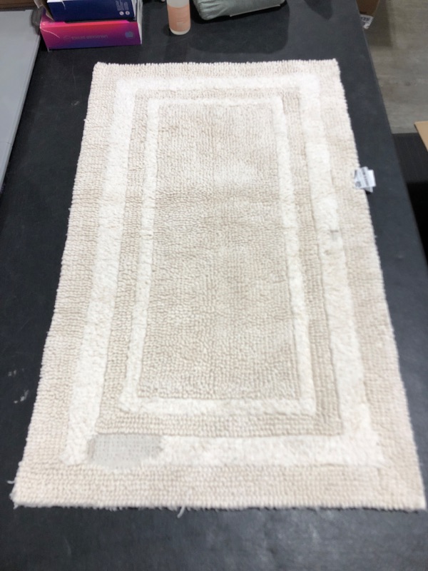 Photo 2 of 20 X 34 PERFORMANCE BATH MAT. CREAM COLORED. PRIOR USE. THREAD DAMAGE TO BOTTOM