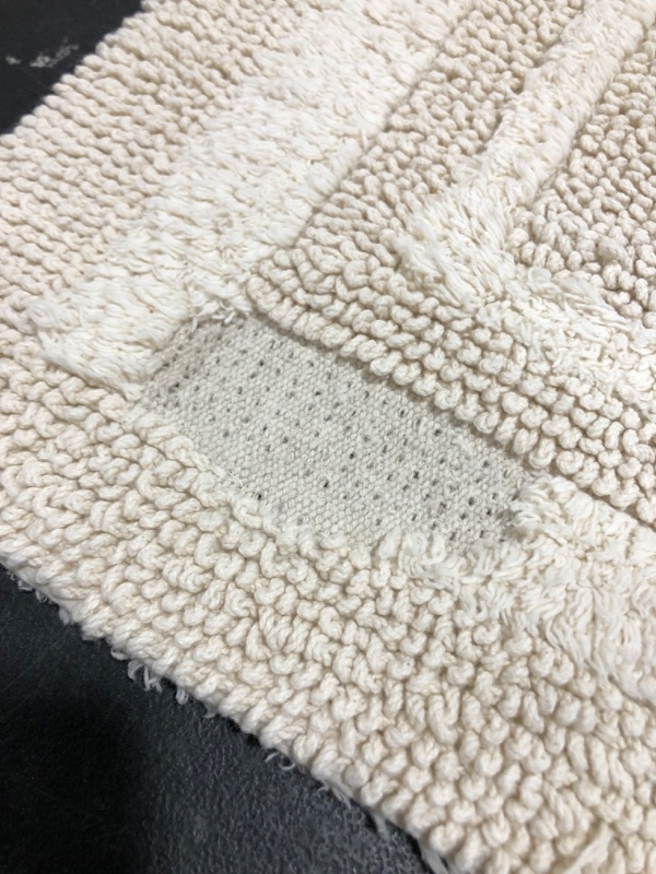 Photo 1 of 20 X 34 PERFORMANCE BATH MAT. CREAM COLORED. PRIOR USE. THREAD DAMAGE TO BOTTOM