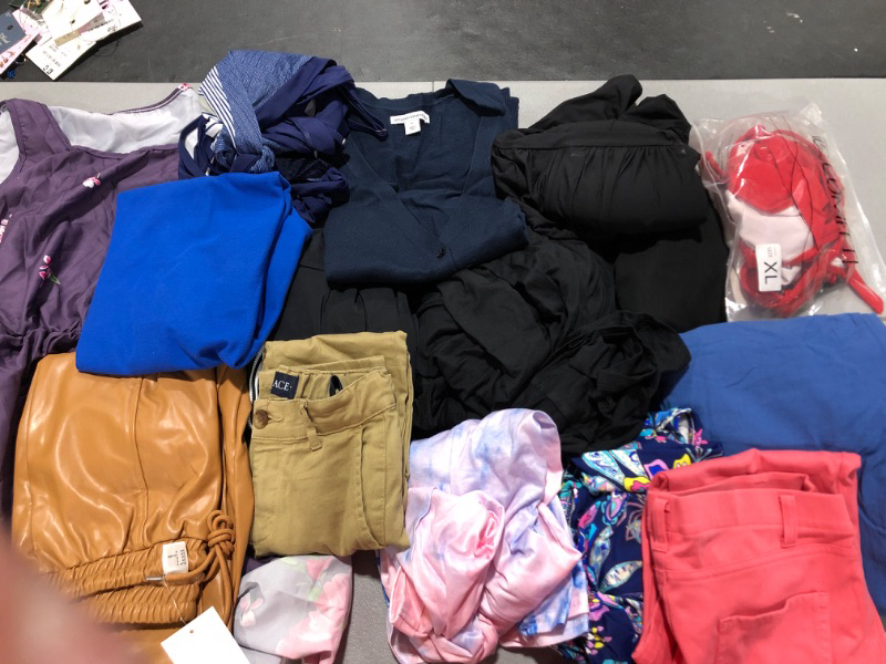 Photo 1 of Clothing lot. Various sizes of misc. clothing for men, women, and kids. Sold as is.