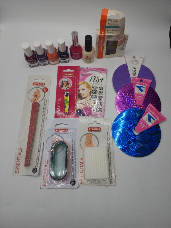 Photo 1 of Variety Nail Kit 7 Nail Polishes, 1 Decal Set, 1 Nail Clipper, 1 Pumice Stone, 1 Pack of Thing Nail Files, 3 Wheel Nail Files, and a Buffer Stone 