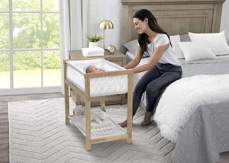 Photo 1 of Delta Children Classic Wood Bedside Bassinet Sleeper Portable Crib with HighEnd Wood Frame, Paint Dabs