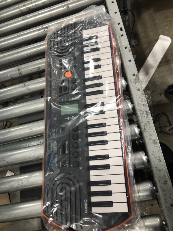 Photo 1 of Casio SA-76 44 Key Mini Keyboard, Orange