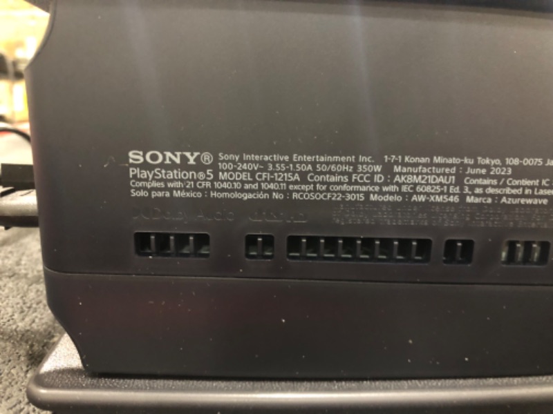 Photo 1 of SCRATCHED; PlayStation 5 Console THIS IS NOT THE AMAZON LISTED BUNDLE; THEREFORE, THE PACKAGE DOES NOT INCLUDE "VAUCHER FOR A DIGITAL COPY OF THE STANDARD EDITION OF THE GAME." PACKAGE ONLY INCLUDES CONSOLE, REMOTE, BASE, AND POWER CORDS. 