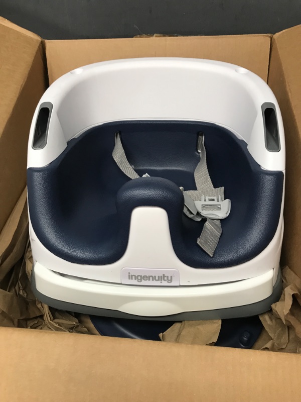 Photo 1 of blue and white booster seat 