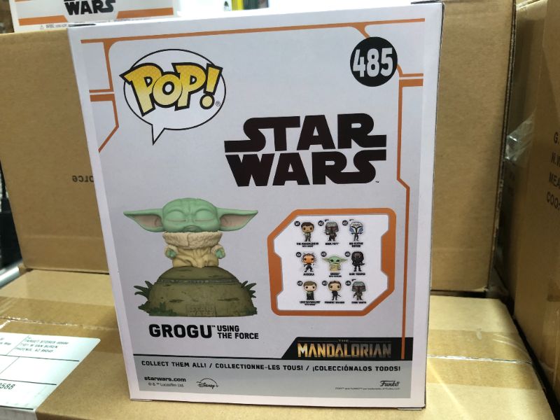 Photo 1 of Funko POP! Deluxe: The Mandalorian - Grogu seated on a Seeing Stone, STAR WARS™ The Mandalorian™ with Pop! Deluxe Grogu This special figure also emits sounds and lights up. Vinyl bobblehead is approximately 4.75-inches tall.