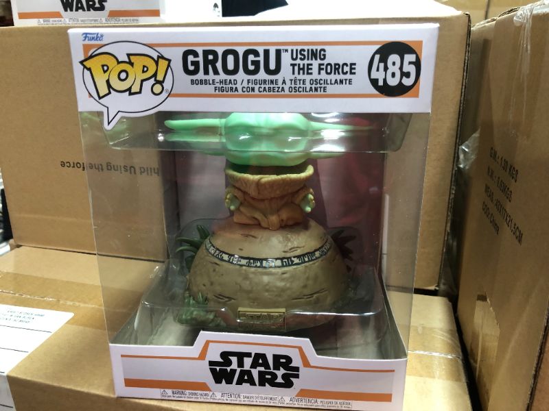 Photo 1 of Funko POP! Deluxe: The Mandalorian - Grogu seated on a Seeing Stone, STAR WARS™ The Mandalorian™ with Pop! Deluxe Grogu This special figure also emits sounds and lights up. Vinyl bobblehead is approximately 4.75-inches tall.