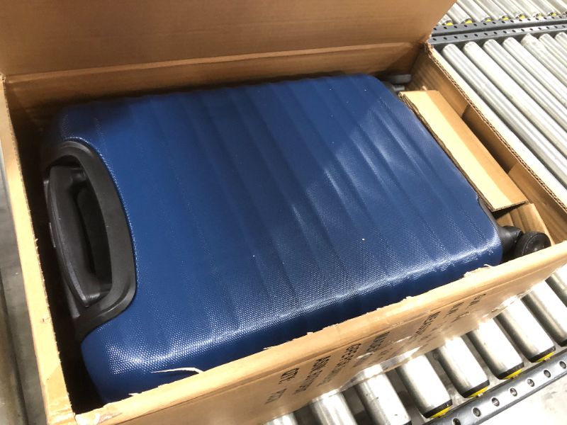 Photo 2 of AmazonBasics Hardside Carry On Spinner Travel Luggage Suitcase - 20 Inch, Navy Blue
