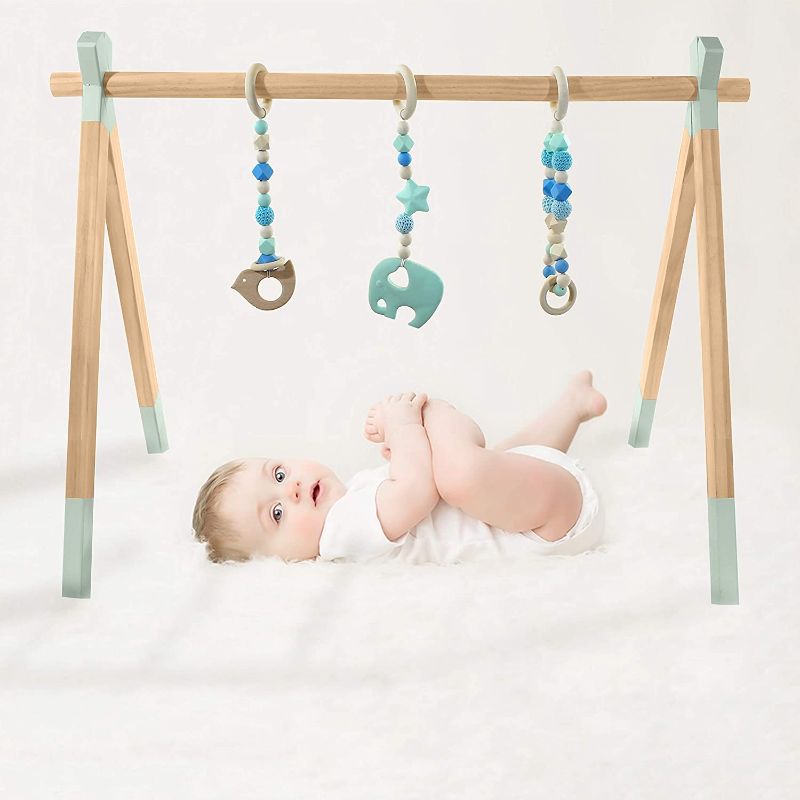 Photo 1 of Busterbooty's Wooden Play Gym for Baby, Infant Boy or Girl Eco Friendly Activity mat for Tummy time 3 Hanging Toy bar, Easy Installation Play Gym Frame Center Safe Durable, Newborn Gift (Light Blue)
