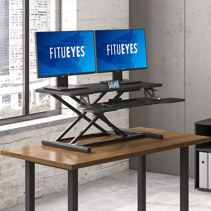 Photo 1 of FITUEYES Height Adjustable Standing Desk 36” Wide Sit to Stand Converter Stand Up Desk Tabletop Workstation for Laptops Dual Monitor Riser Black SD309101WB