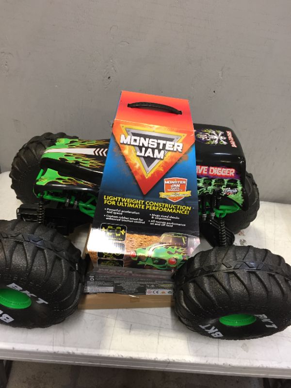 Photo 2 of Monster Jam Official Mega Grave Digger All-Terrain Remote Control Monster Truck with Lights 1: 6 Scale Kids Toys for Boys (BACK TIRE IS BROKEN)
