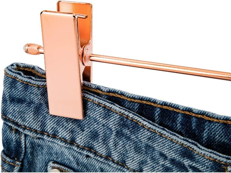 Photo 4 of Jetdio Metal Heavy Duty Pants Skirt Slack Hangers,Trousers Hangers with Two Adjustable Non Slip Clips Hanger Rack Swivel Hook, 12 Pack, Copper Gold
