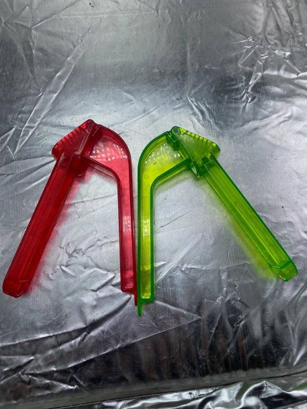 Photo 1 of plastic garlic press, colors green and red 