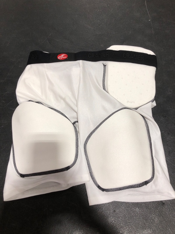 Photo 1 of KRAMER PADDED PROTECTIVE SHORTS, WHITE, SIZE YOUTH XL. PRIOR USE. MISSING PACKAGE.