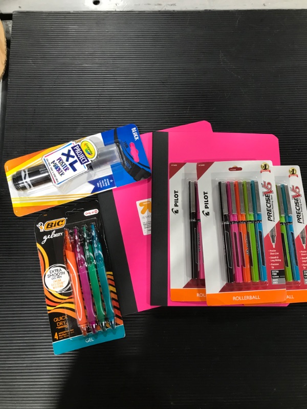 Photo 1 of A box lot of miscellaneous school supplies, including notebooks, pens, and poster marker. 