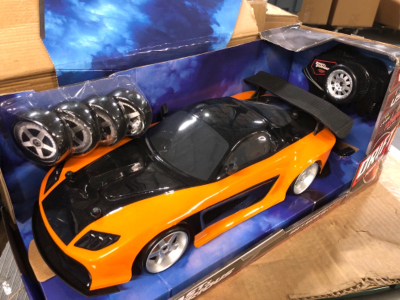 Photo 2 of Jada Toys Fast & Furious Han’s Mazda RX-7 Drift RC Car, 1: 10 Scale 2.4Ghz Remote Control Orange & Black, Ready to Run, USB Charging (Standard) (99700)