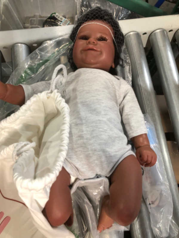 Photo 1 of Doll Reborn Lifelike Reborn Baby Dolls Black Girl, 22 Inch, Grey One Piece with a pacifier and a baby bottle 