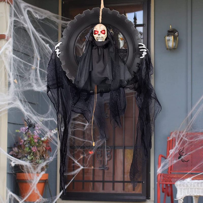 Photo 1 of 2--0MAOYUE Hanging Skull Head Animated Outdoor Halloween Decorations, Animated Talking Moving Skeleton Head Reaper in Tire Swing Prop Decoration
