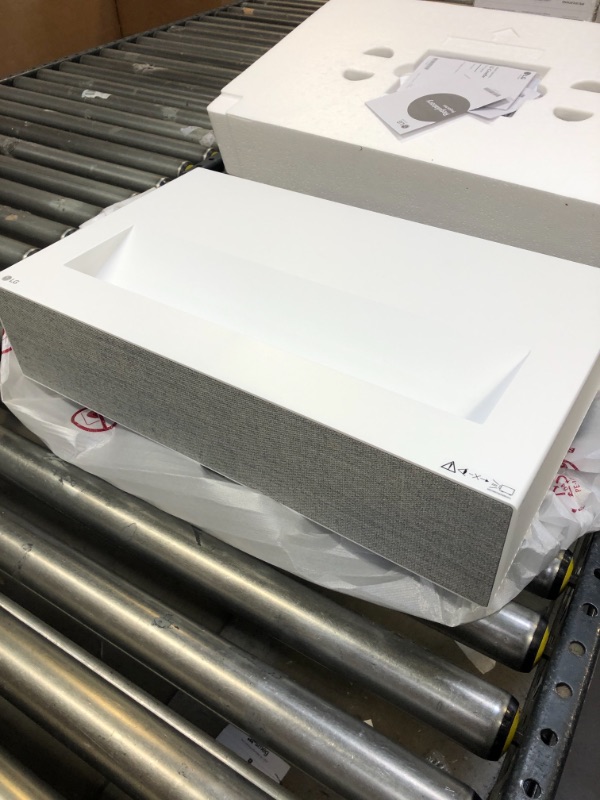 Photo 2 of LG CineBeam UHD 4K Projector HU715QW - DLP Ultra Short Throw Laser Smart Home Theater Projector, White ( new but box has been opened ) 