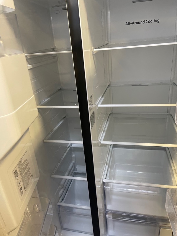 Photo 4 of Samsung - 27.4 Cu. Ft. Side-by-Side Refrigerator - Black stainless steel, INTERIOR VERY CLEAN, EXTERIOR DIRTY/SCUFFED FORM NOT BEING PACAKGED. 
