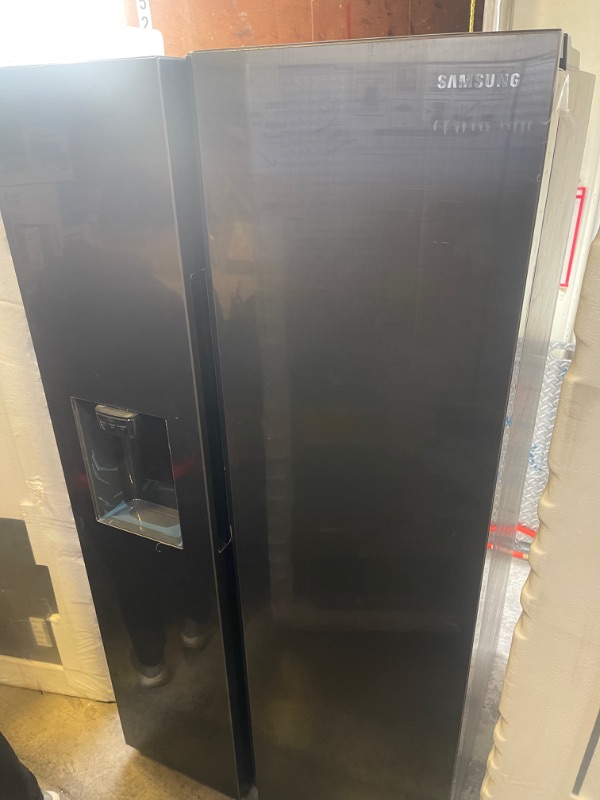 Photo 2 of Samsung - 27.4 Cu. Ft. Side-by-Side Refrigerator - Black stainless steel, INTERIOR VERY CLEAN, EXTERIOR DIRTY/SCUFFED FORM NOT BEING PACAKGED. 
