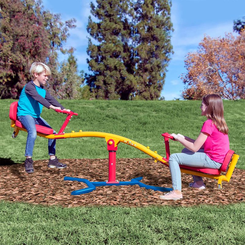 Photo 1 of gym dandy Spinning Teeter Totter - Impact Absorbing Kids Playground Equipment - 360 Degree Rotation, Red, Yellow & Blue, 99 Inch, (TT360), Box Packaging Damaged, Item is Factory Sealed, Opened for Inspection. Item is New
