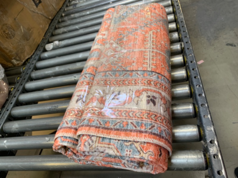 Photo 1 of 7'x10' Orange Patterned Rug, No Box Packaging, Minor Use, Minor Fraying on Edges, Creases and Wrinkles in Rug, Dirty From Shipping and Handling, Tape on Rug
