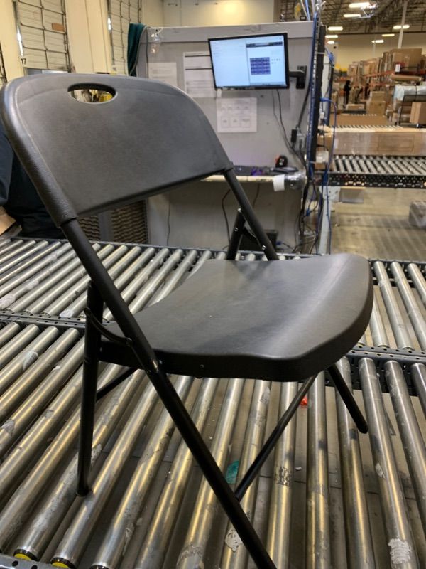 Photo 1 of Amazon Basics Folding Plastic Chair with 350-Pound Capacity - Black --- No Box Packaging, Minor Use, Slightly Dirty from Shipping