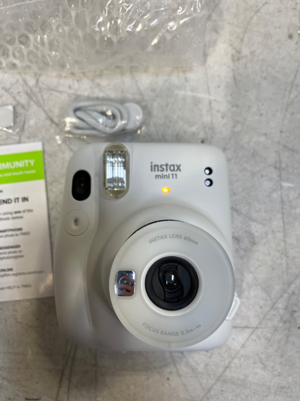 Photo 2 of INSTAX 11 - ITEM WAS IN A BOX WITH WATER DAMAGE , ALL PAPERS INCLUDE GOT DAMAGED HOWEVER ITEMS ITSELF IS NOT DAMAGED AND STILL WORKS - SEE PHOTOS