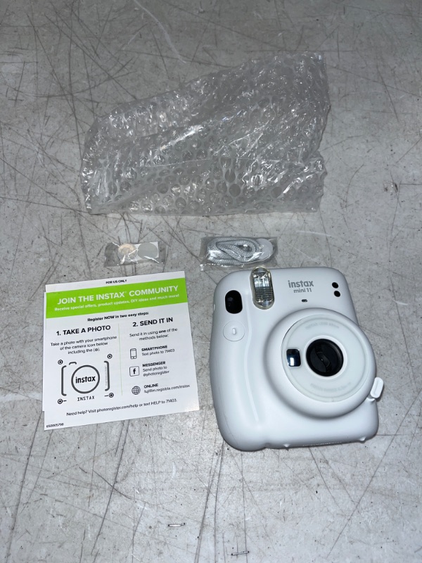 Photo 1 of INSTAX 11 - ITEM WAS IN A BOX WITH WATER DAMAGE , ALL PAPERS INCLUDE GOT DAMAGED HOWEVER ITEMS ITSELF IS NOT DAMAGED AND STILL WORKS - SEE PHOTOS