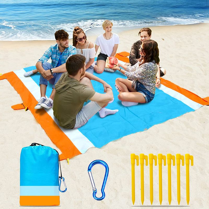 Photo 1 of Beach Blanket-79 X 83" Sandproof Waterproof Lightweight Portable Beach Mat with 7 Plastic Floor, 210D Nylon Picnic Pocket Blanket for Park Beach Hiking Camping (Orange-Blue)
