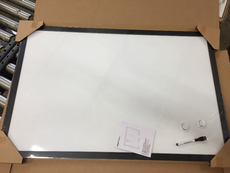 Photo 2 of Amazon Basics Magnetic Dry Erase White Board, 35 x 23-Inch Whiteboard - Black Wooden Frame 23"x35" Magnetic, Wood Frame