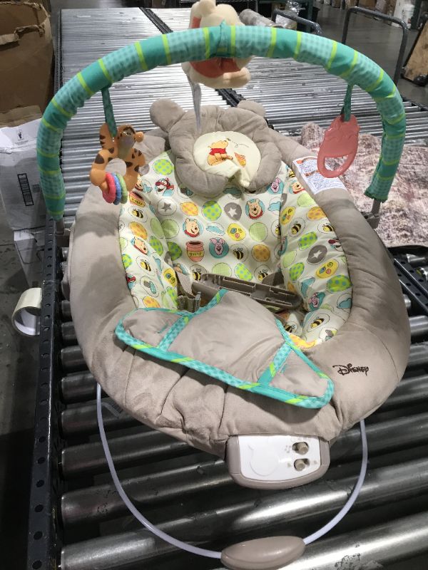 Photo 2 of Bright Starts Winnie the Pooh Dots & Hunny Pots Baby Bouncer with Vibrating Infant Seat, Music & 3 Playtime Toys, 23x19x23 Inch
