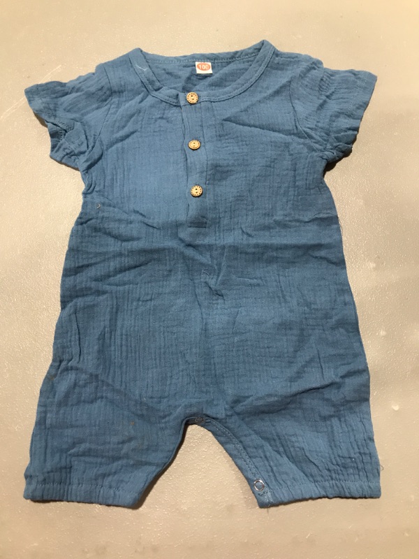 Photo 1 of Blue baby romper with wooden buttons, size unknown.