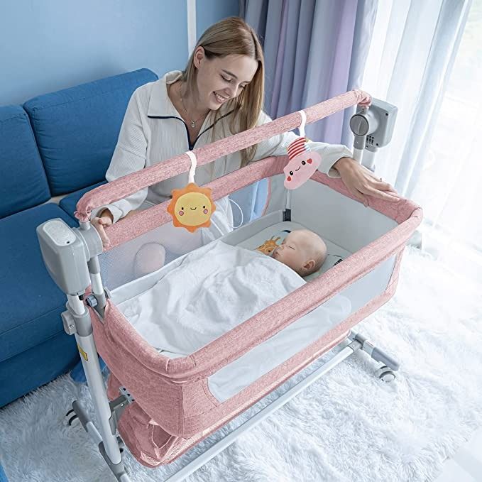 Photo 1 of BABY K Electronic Rocking Bedside Bassinet (Pink) - 4 in 1 Automatic Swaying Mesh Baby Bassinet Co Sleeper Crib with 5 Swing Motions, 3 Timer Setting & Bluetooth Music Control for Infant & Toddlers
