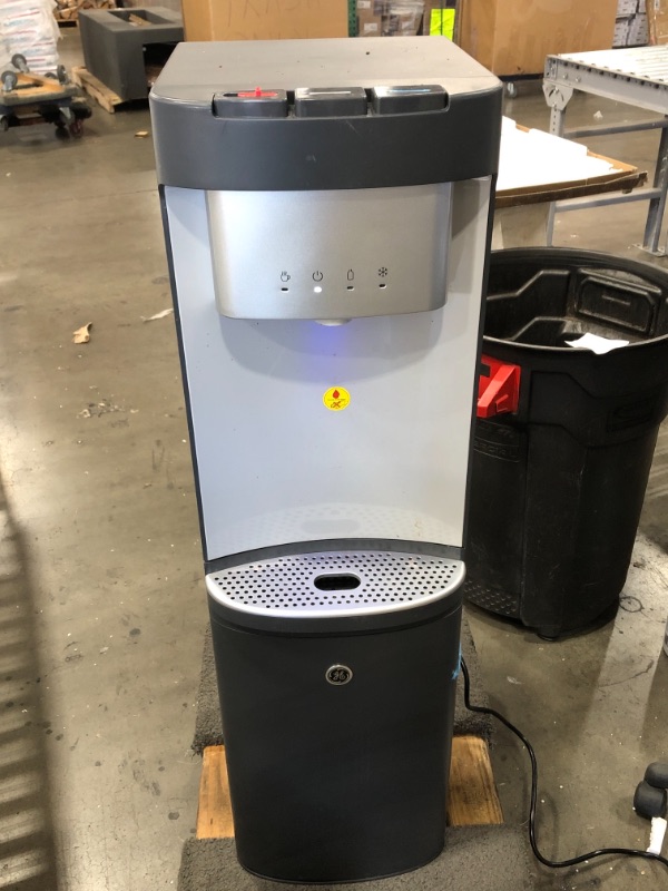 Photo 1 of USED: GE Bottom-Loading Tri-Temperature Water Dispenser | 5 Gallon Water Cooler for Home or Office | 3 Temperature Settings | Taller 13" Dispenser Height | No Lift Bottom Loading | LED Light | Charcoal 13.6 x 12.2 x 43.15 inches

