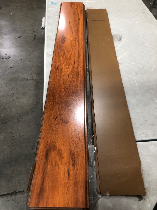 Photo 2 of **DAMAGED** TrafficMaster
High Gloss Jatoba 8 mm Thick x 5-5/8 in. Wide x 47-3/4 in. Length Laminate Flooring (18.65 sq. ft. / case)