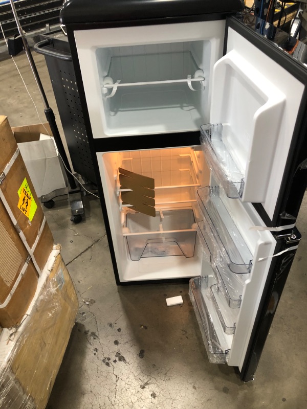 Photo 2 of PARTS ONLY DOES NOT GET COLD 
Galanz GLR46TBKER Retro Compact Refrigerator, 4.6 Cu.Ft Mini Fridge with Dual Door, Adjustable Mechanical Thermostat with True Freezer, Black

-small dent on the side 