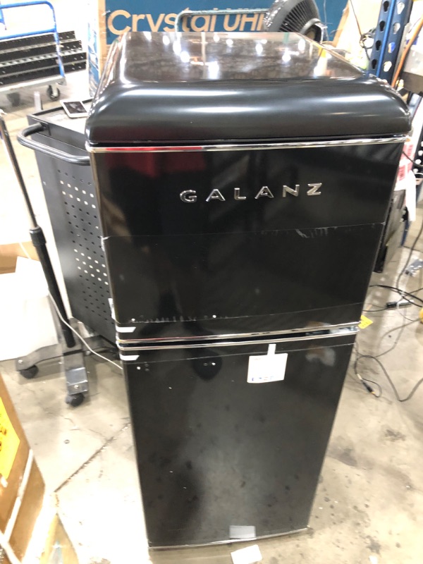 Photo 3 of PARTS ONLY DOES NOT GET COLD 
Galanz GLR46TBKER Retro Compact Refrigerator, 4.6 Cu.Ft Mini Fridge with Dual Door, Adjustable Mechanical Thermostat with True Freezer, Black

-small dent on the side 