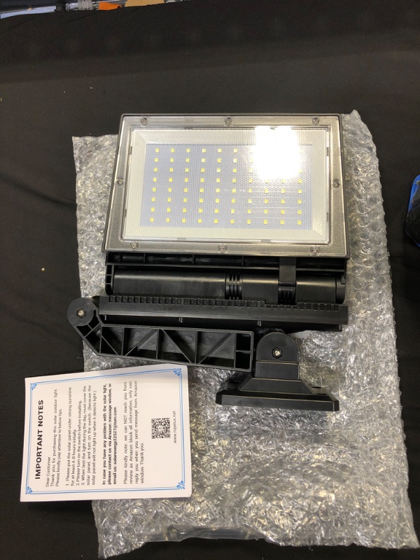 Photo 2 of Ropelux Solar Lights Outdoor, Motion Sensor Outdoor Lights Double Big Solar Panels 82 Sq.Inch, IP65 Waterproof and 3 Modes(Security/Always On/Auto-Dim), 180LEDs High Brightness Wider Illuminated Area. ( BOX HAS SMALL DENT )

